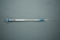 32-wire nitinol braid guide catheter laid straight on slate gray surface with bilateral rim lighting