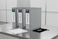 Three printed IQ/OQ/PQ validation binders on brushed-aluminum table with M4D-branded covers, signed Certificate of Validation, and USB evidence drive