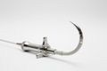 Structural heart steerable delivery catheter with handle in foreground and 90° deflected tip on off-white background
